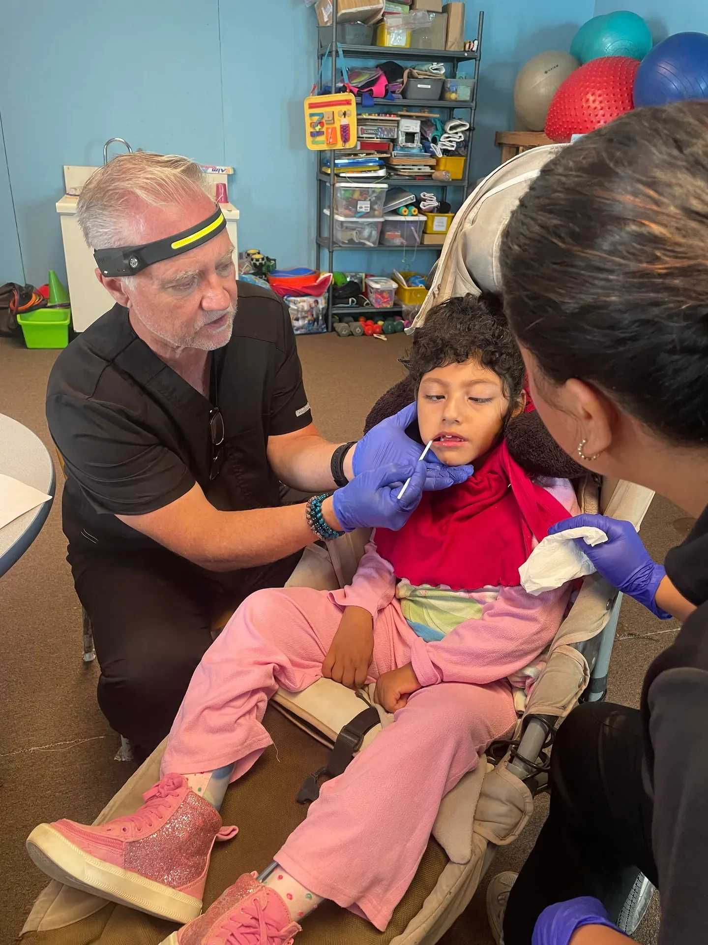 A dentist doing an exam at the Horse Ranch clinic