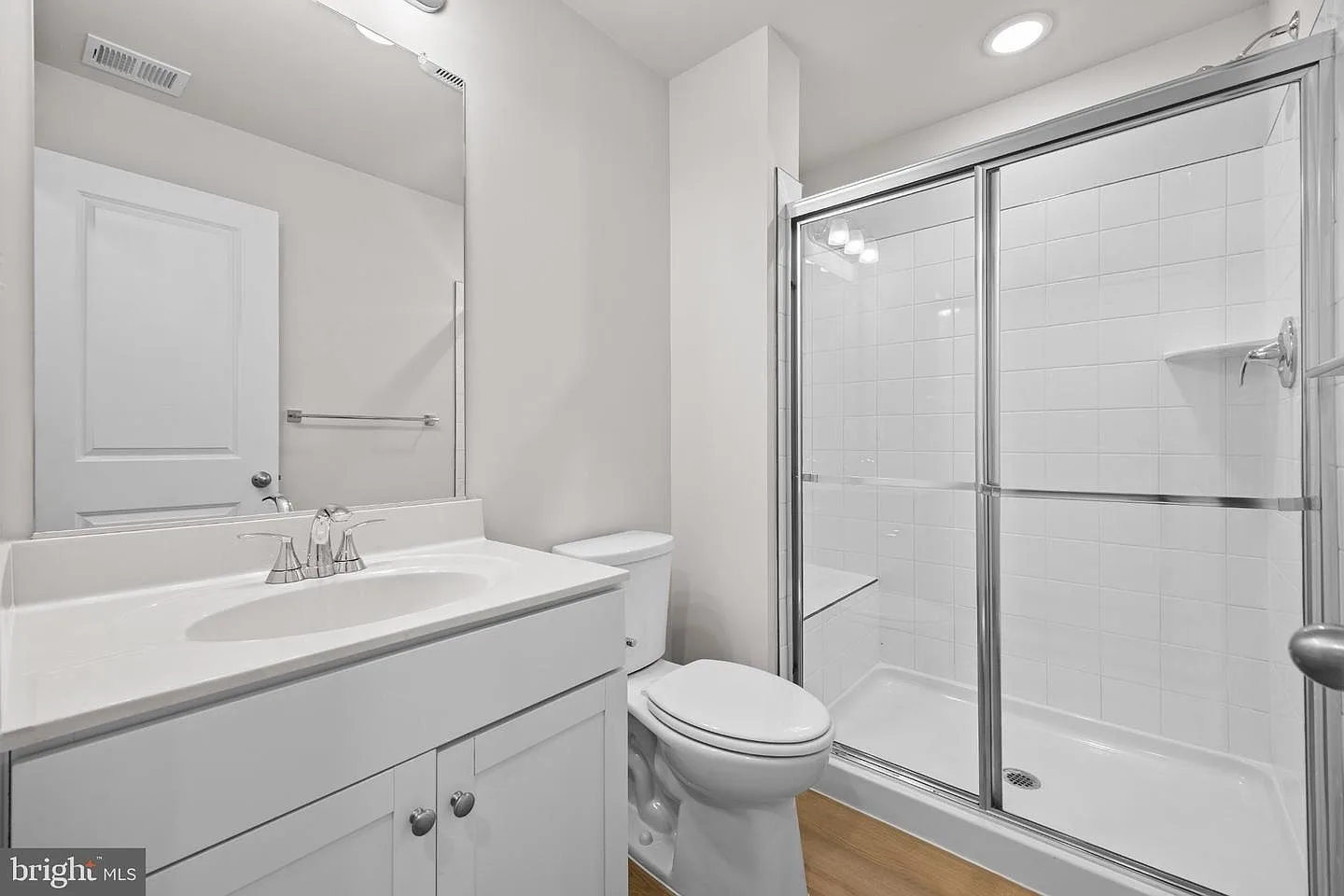 Modern bathroom with walk-in shower and sliding glass doors