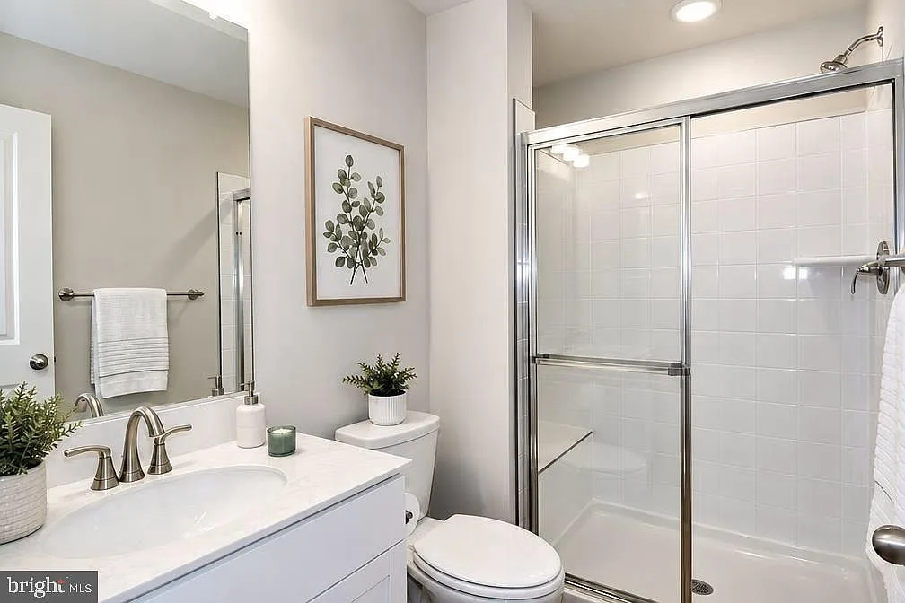 Primary bath with white-tiled walk-in shower