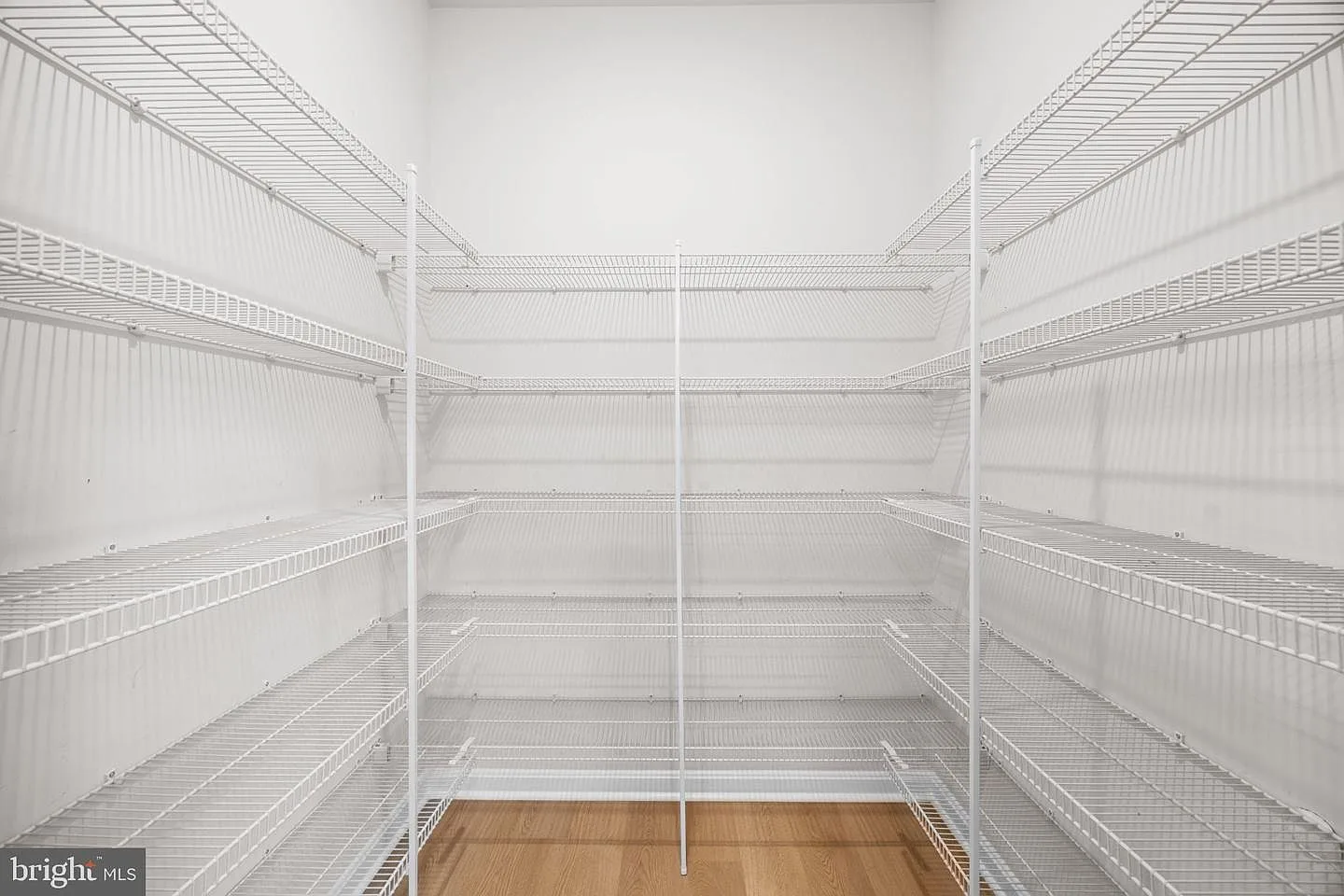 Walk-in pantry with extensive white wire shelving