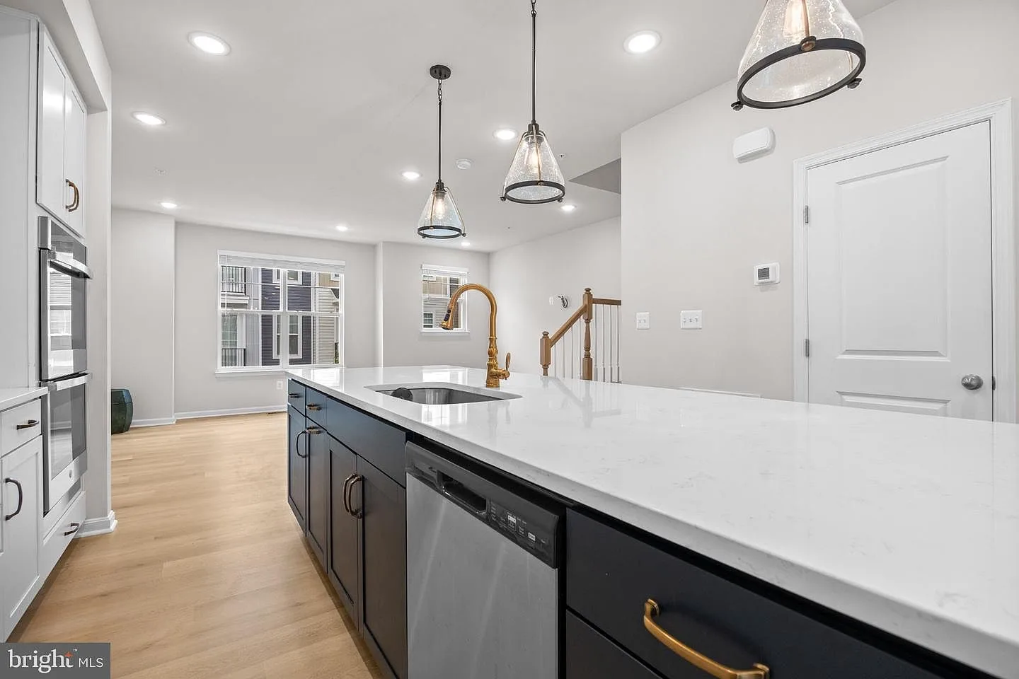 Quartz island with upgraded bronze hardware and stainless steel appliances