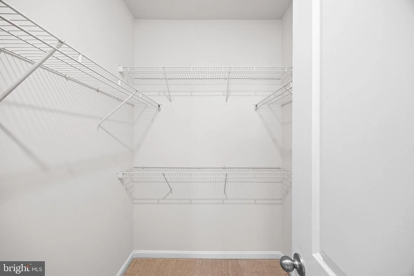 Walk-in closet with white wire shelving