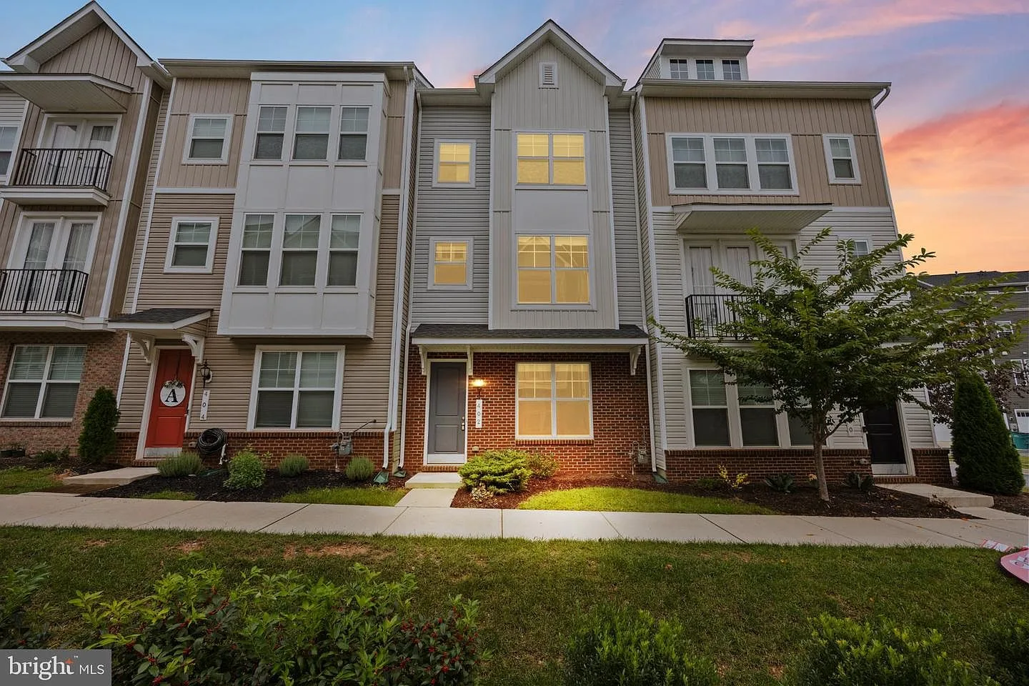 402 Matlock Ln front facade at dusk with landscaped entry, shrubs, lawn, and warm window light