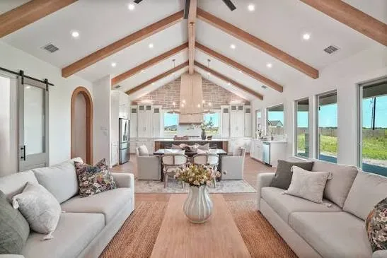 Bright, elegantly staged model home living room with blush and gold accents