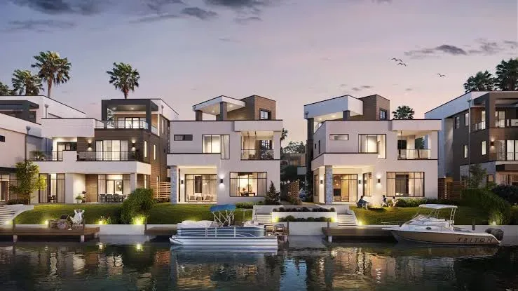 Canal-front coastal modern homes with private docks at golden hour