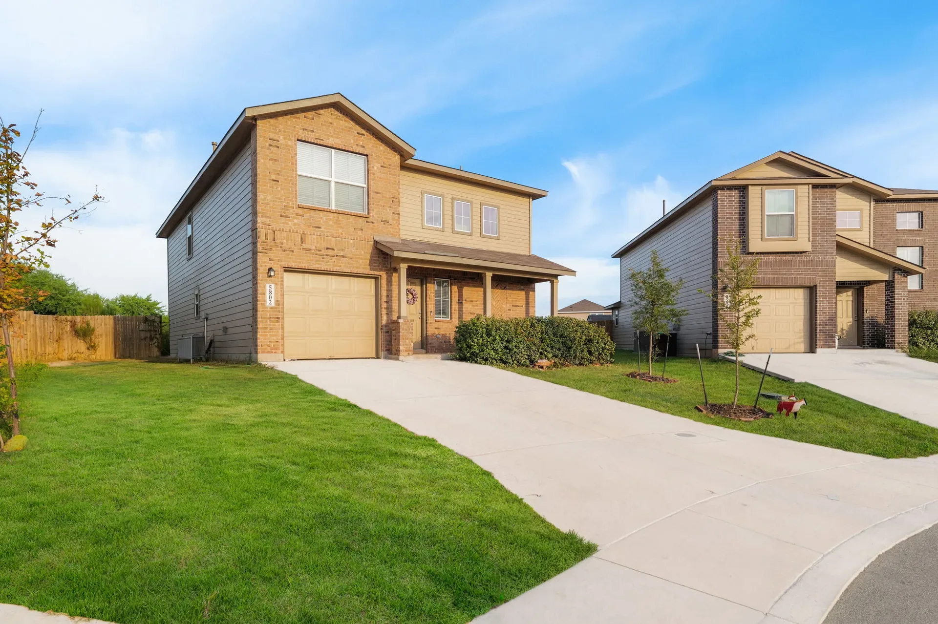 Wide street view of a two-story home in the 78244 corridor of San Antonio