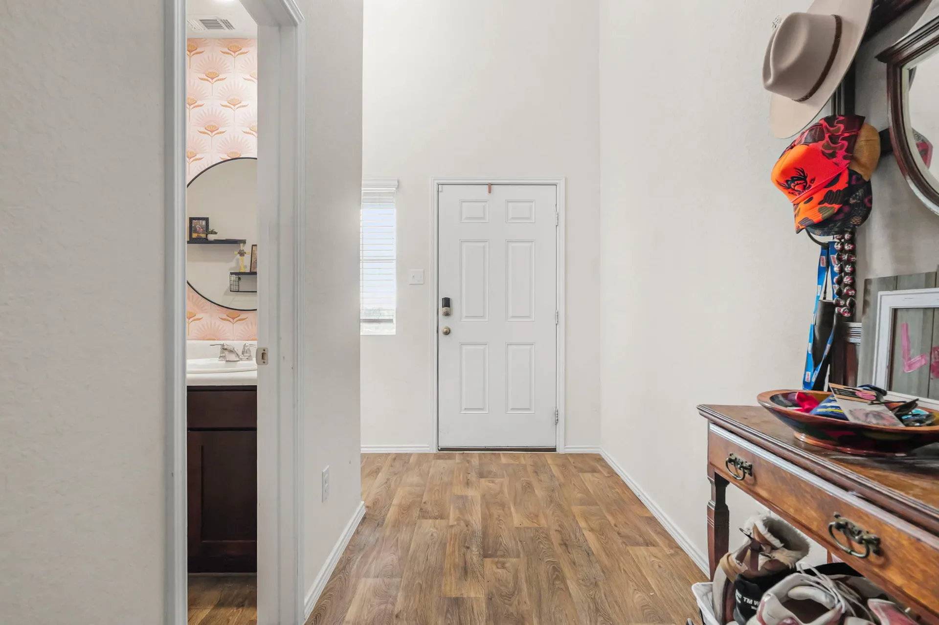 Entry hall with wood-look laminate flooring, high ceilings, and a view to the front door