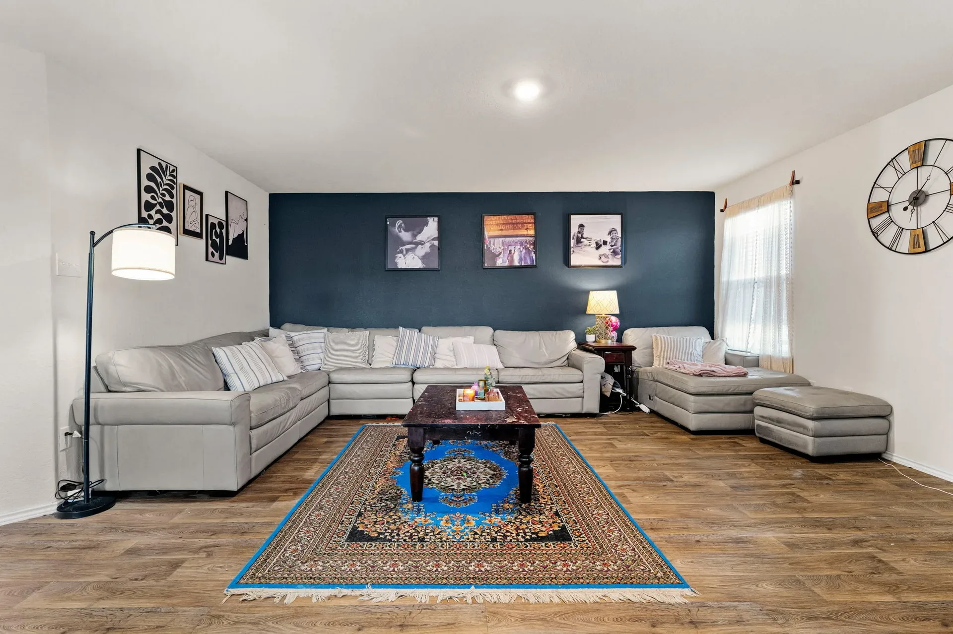 Living room bathed in warm light with a dark blue accent wall