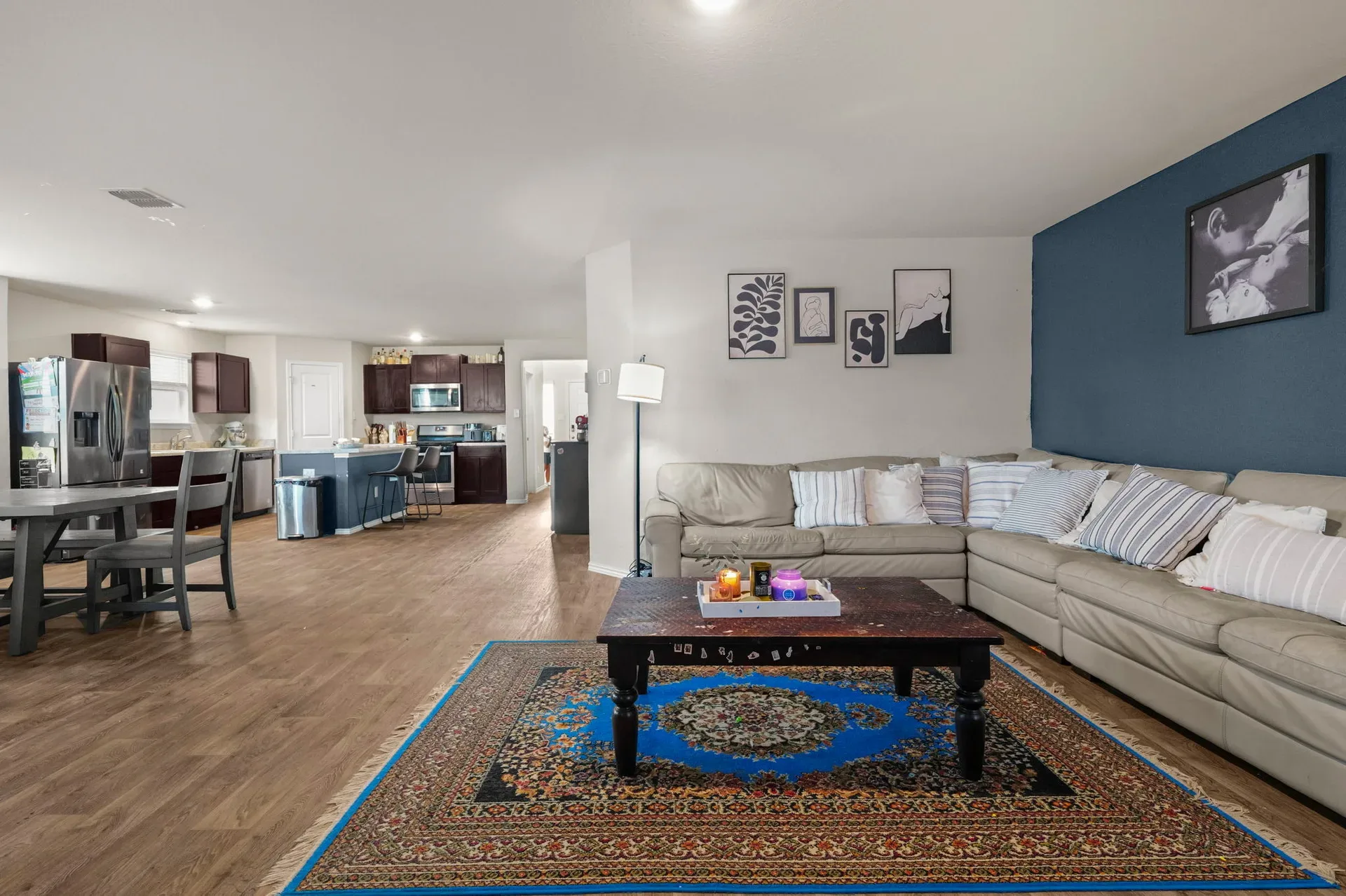 Wide-angle view of the open living, dining, and kitchen space