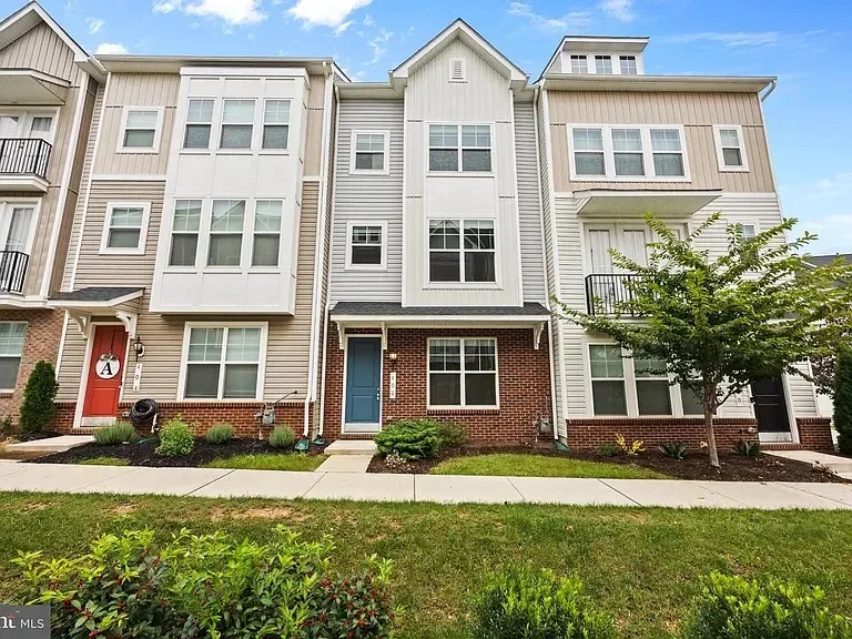 Front facade of 402 Matlock Ln on a clear day, centered on the unit