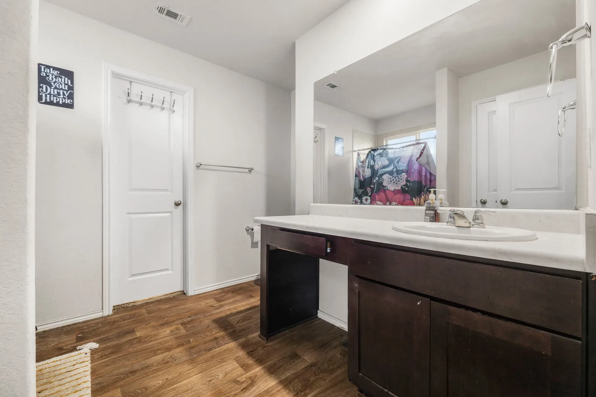 Bathroom with dark espresso vanity and a large wall-to-wall mirror