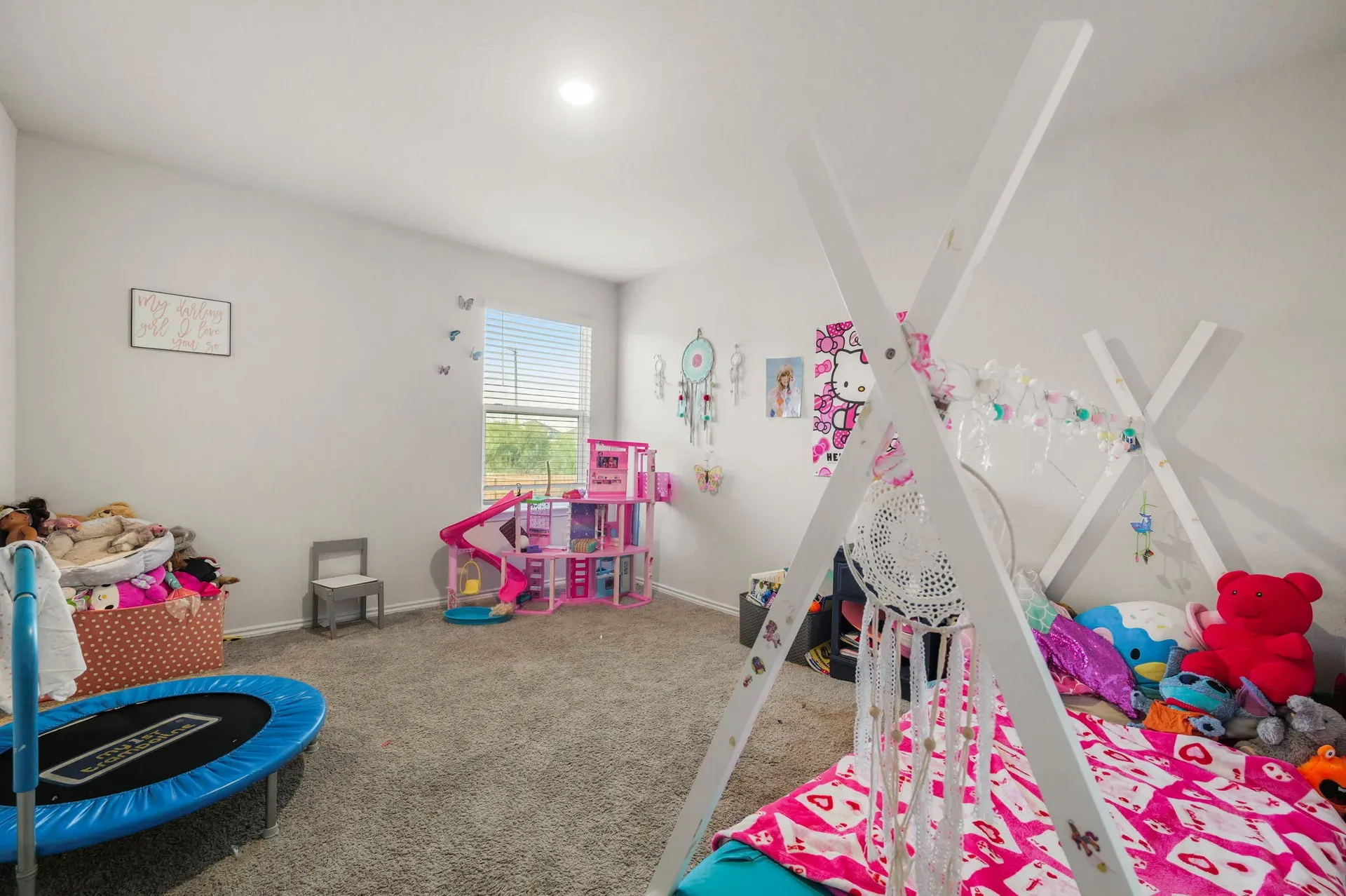 Versatile fourth bedroom currently staged as a children's room
