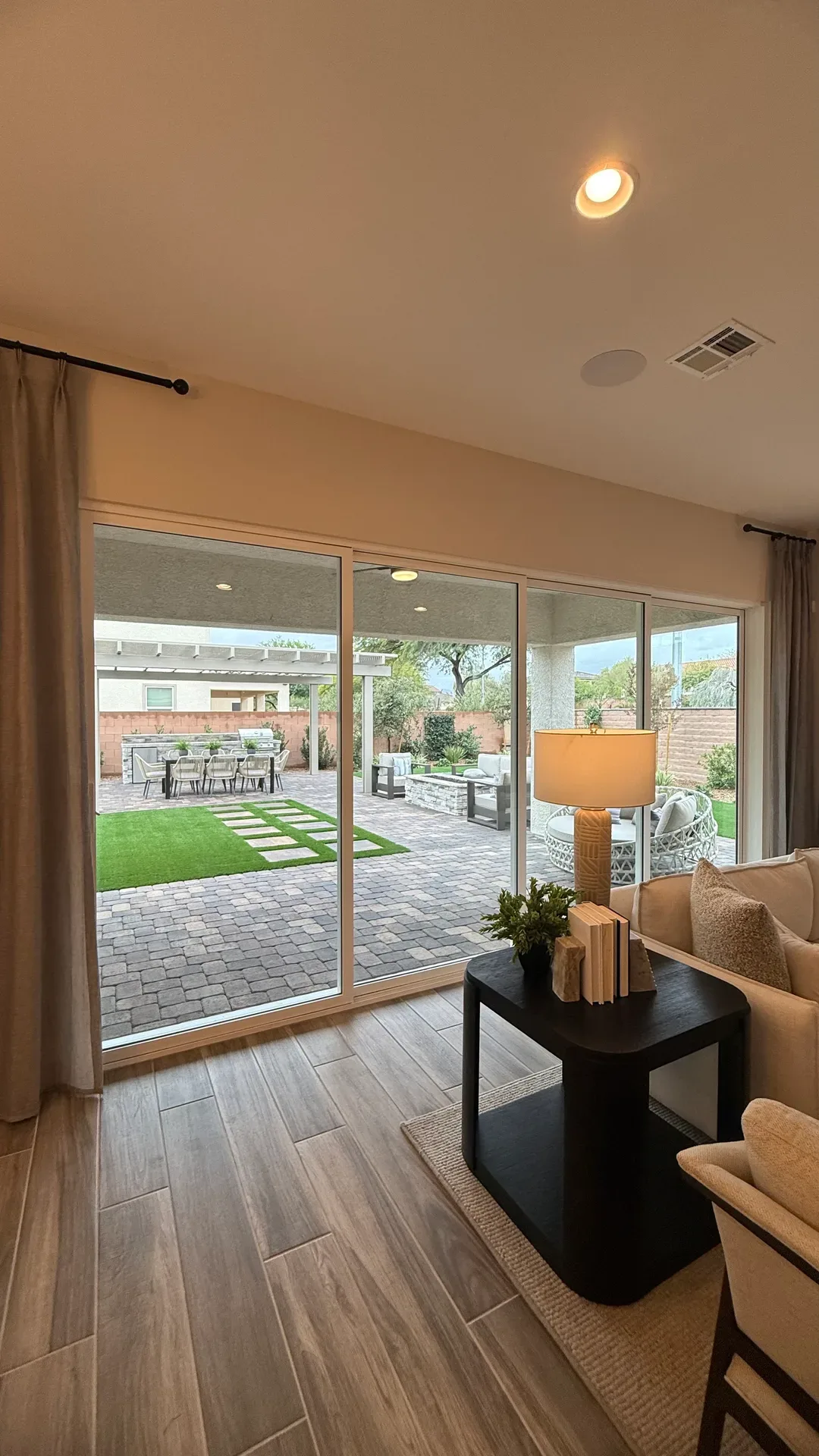 Bright modern Las Vegas living room opening to the backyard through sliding glass doors