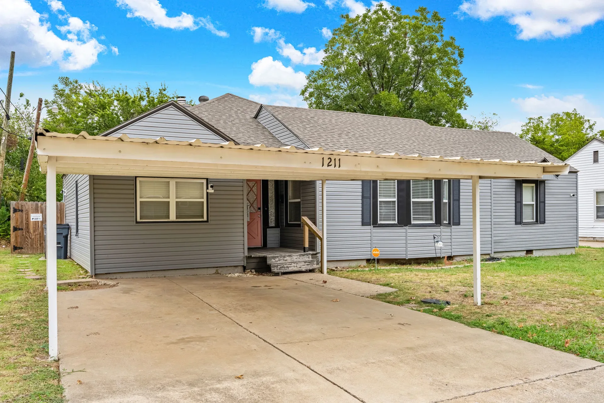 Front entry and carport with house number 1211