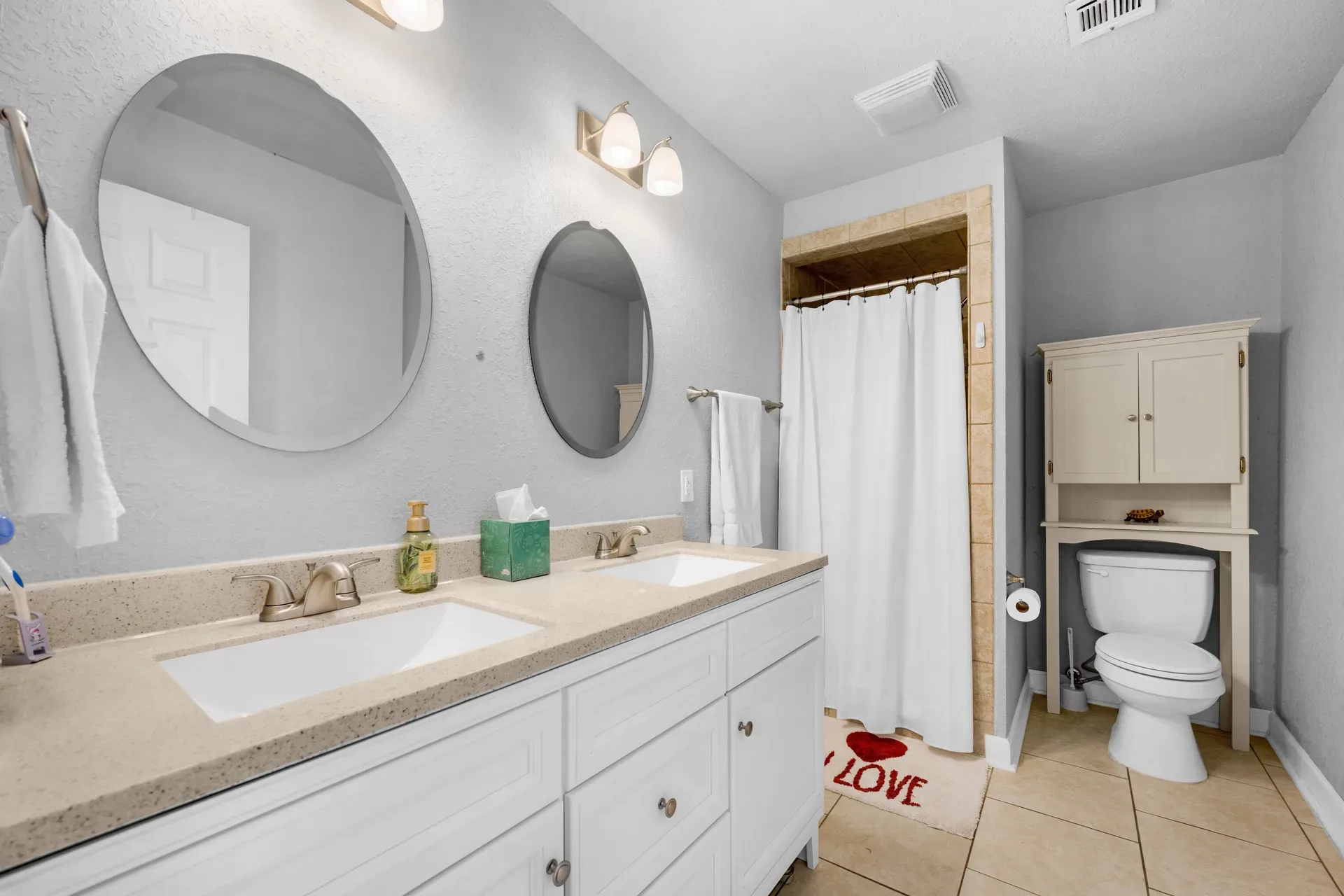 Primary bathroom vanity with mirrors