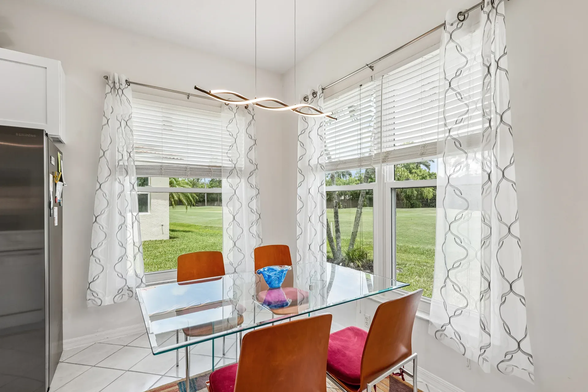 Casual dining space with golf course view and tile flooring