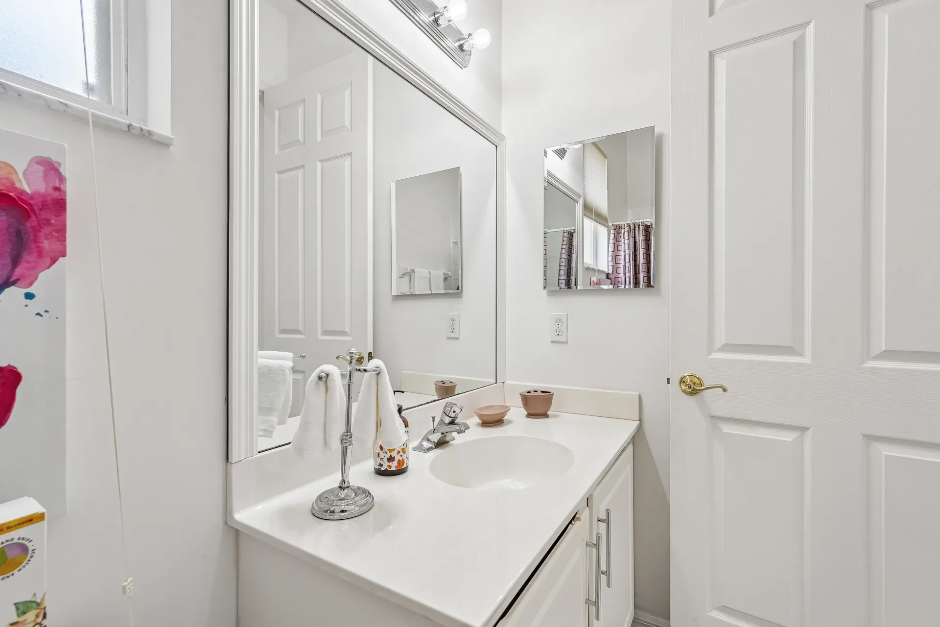 Guest bathroom vanity with white cabinetry and quartz countertop