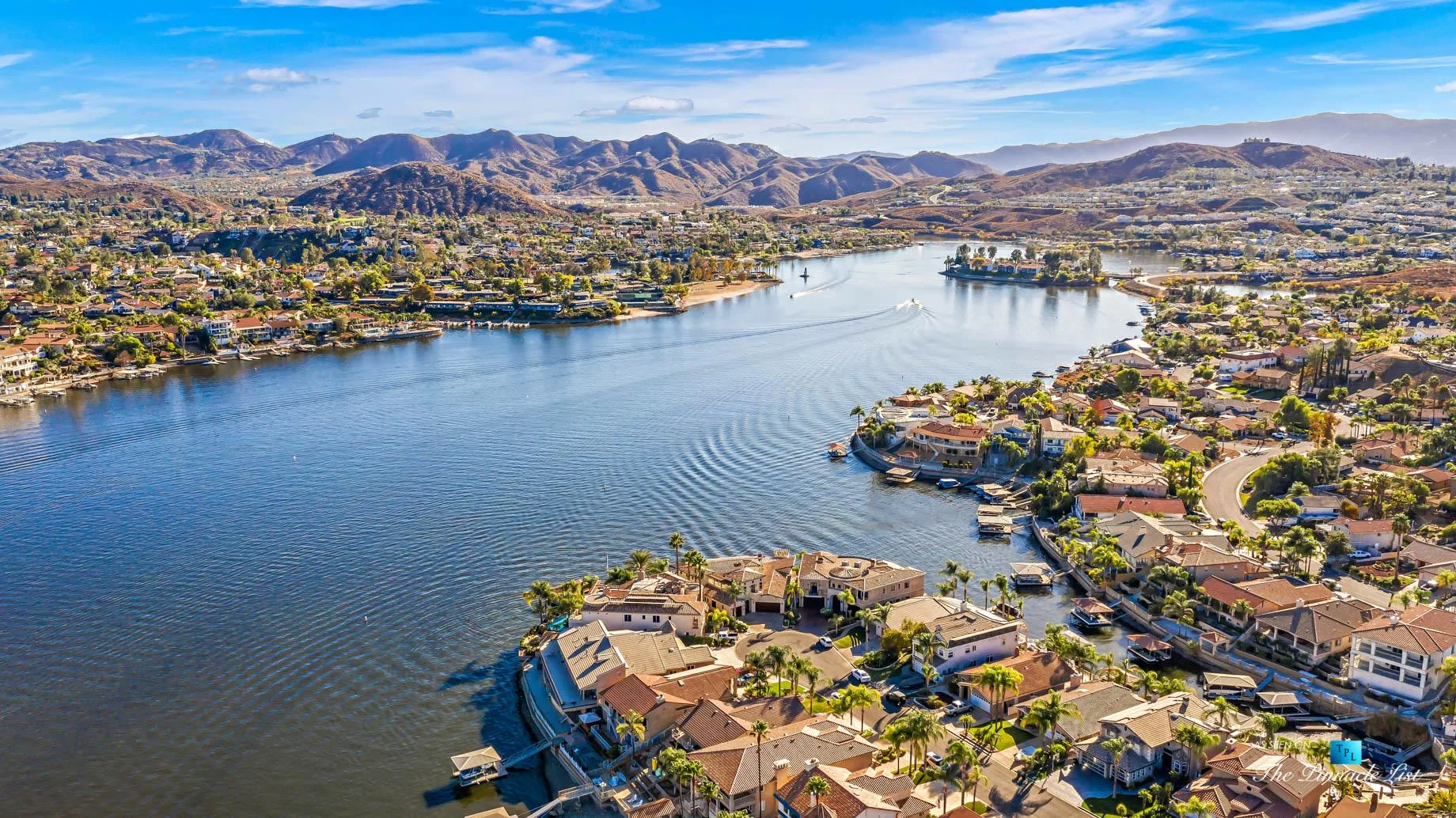 An aerial view of the Canyon Lake community with homes, private docks and boats on the water