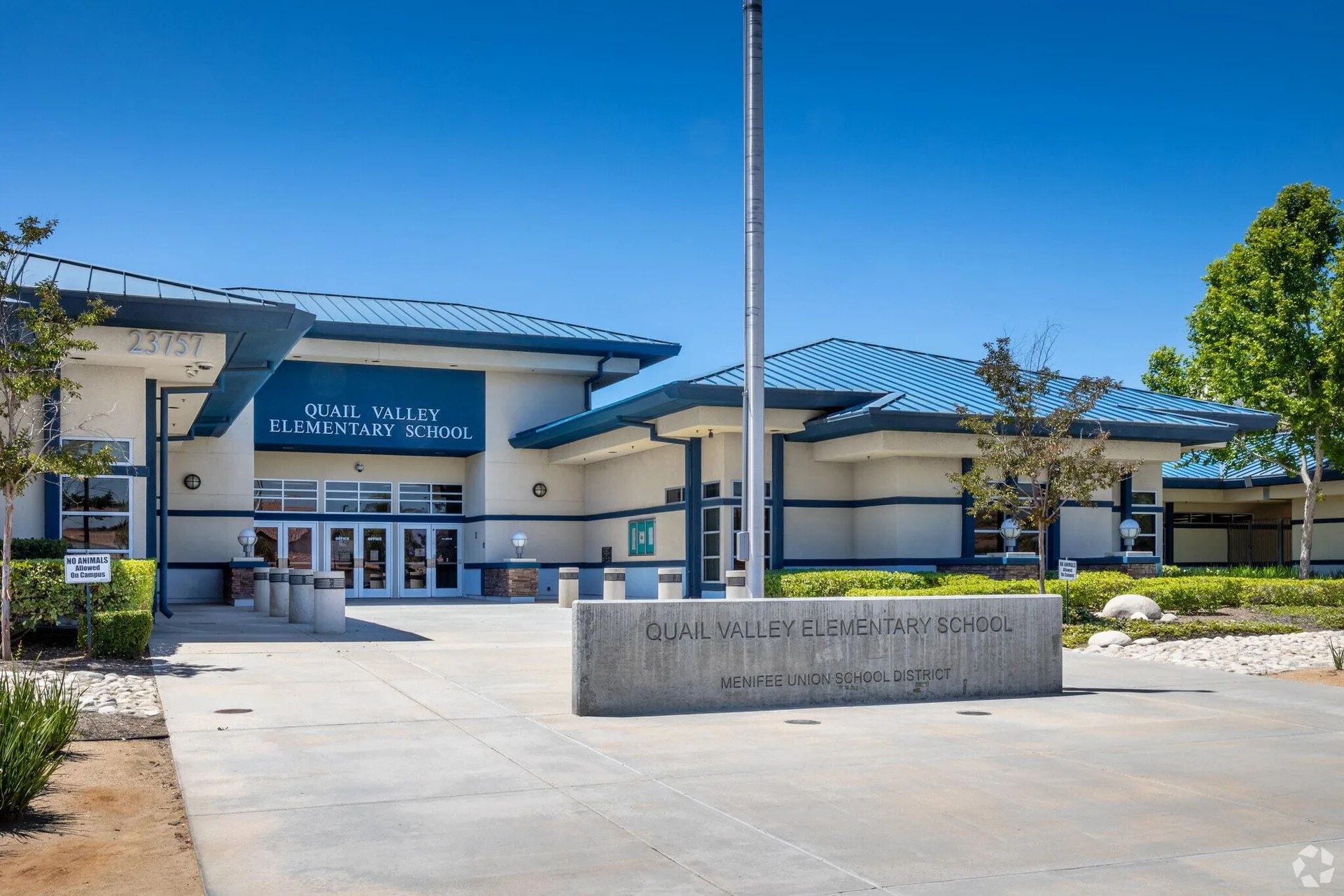 Quail Valley Elementary School exterior with light stucco walls and blue metal roof accents in Menifee