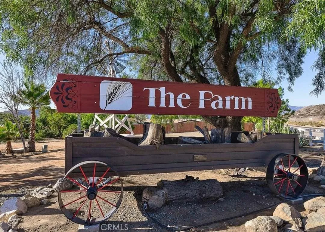 The Farm community entrance sign with a red wooden wagon in Wildomar, California