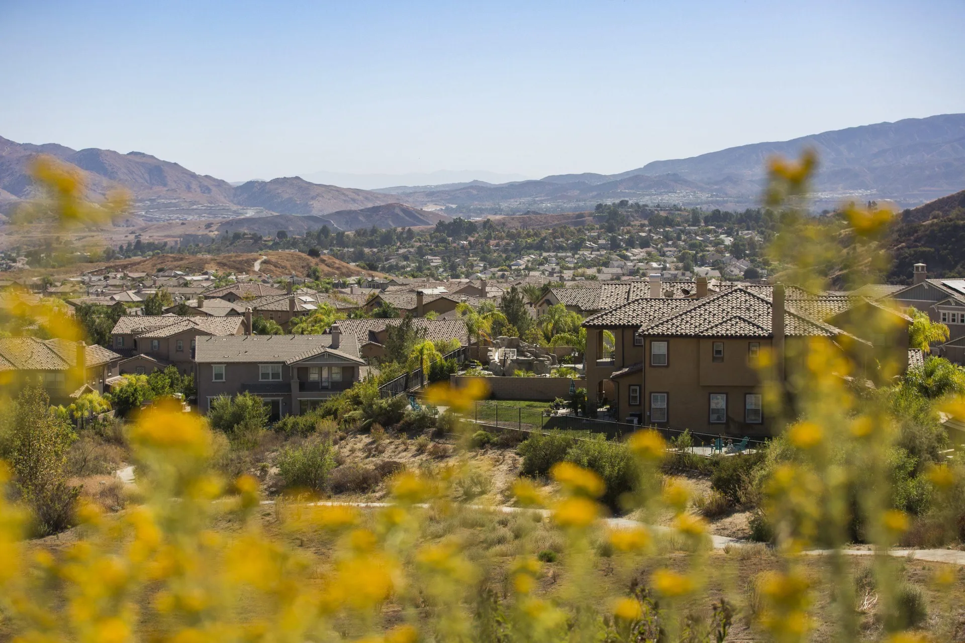A scenic view of the Canyon Hills neighborhood tucked into hills with a desert mountain backdrop