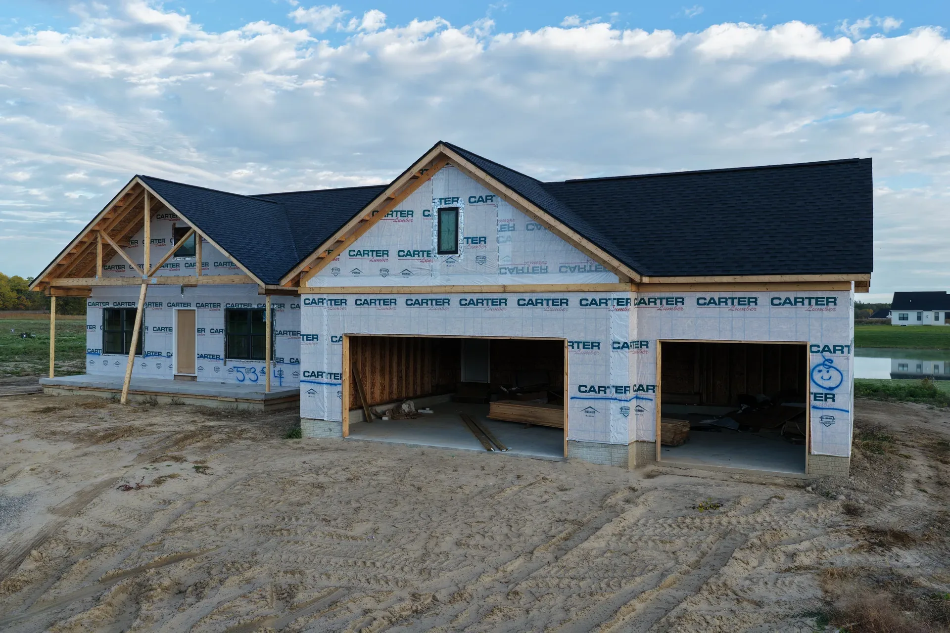 Spec home under construction with wood framing and house wrap
