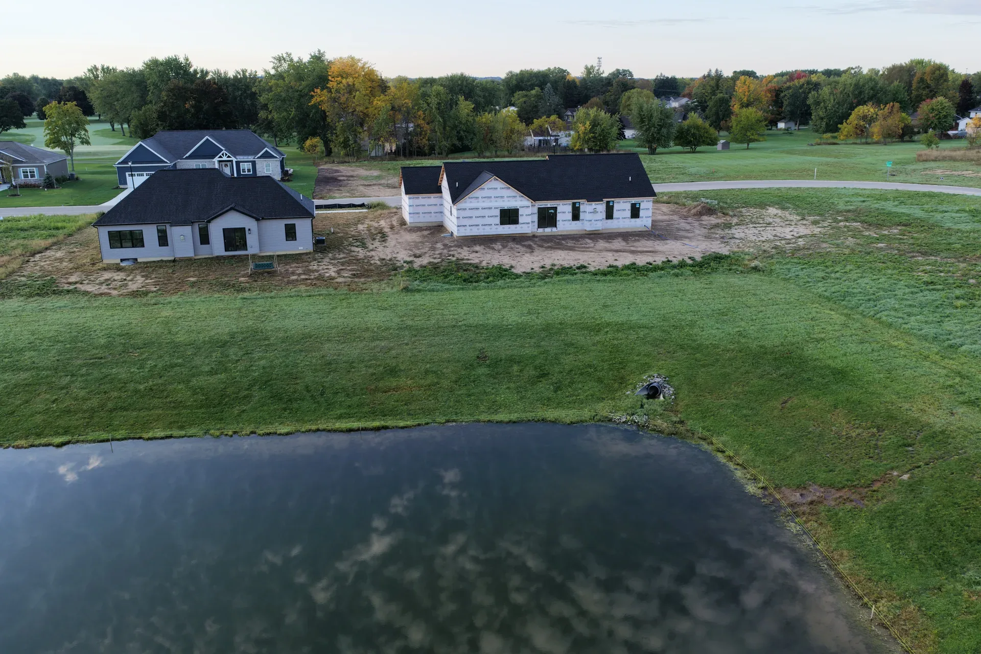 Aerial view of two spec homes in different stages of construction