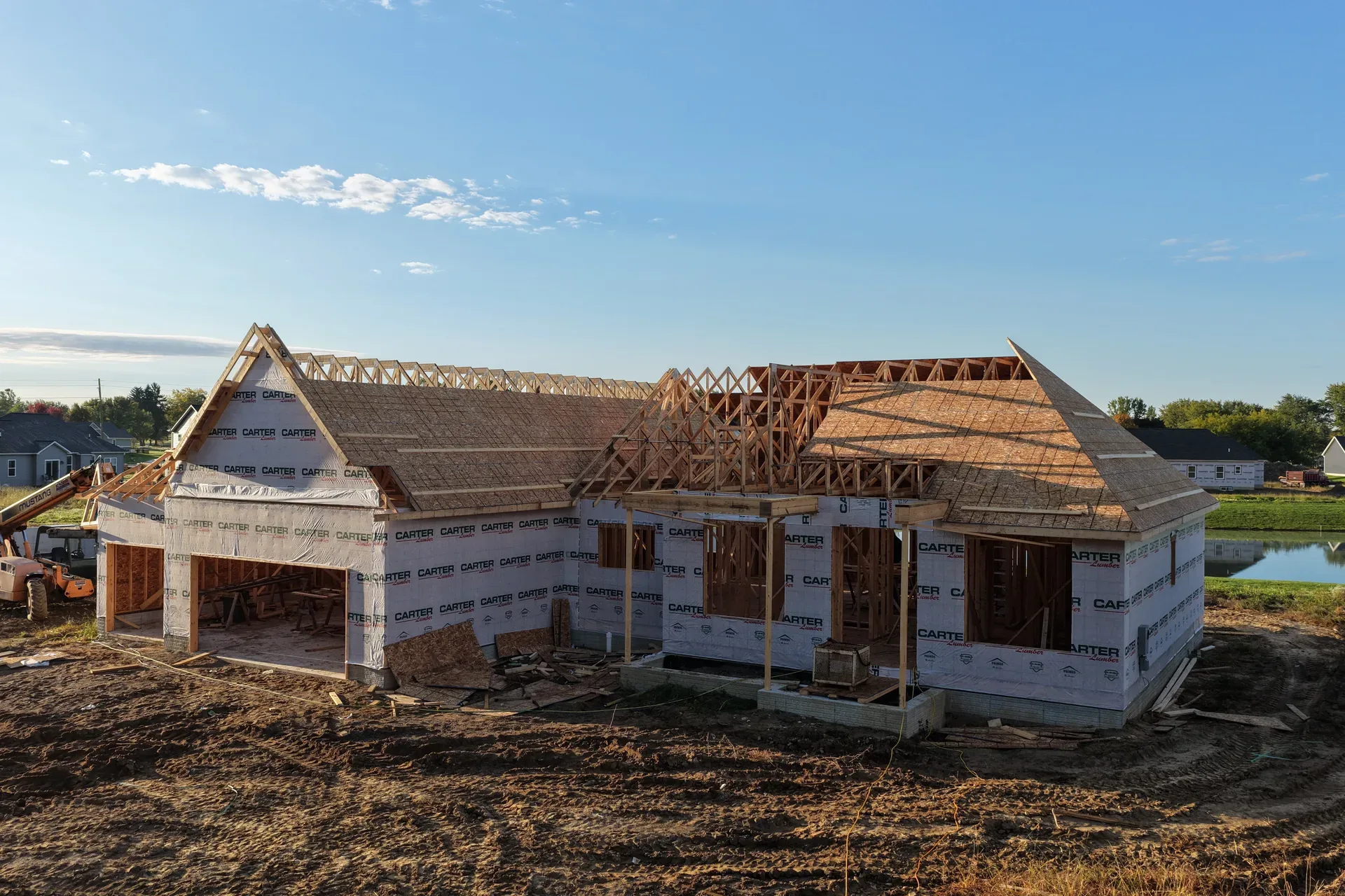 Modern farmhouse spec home framing at golden hour