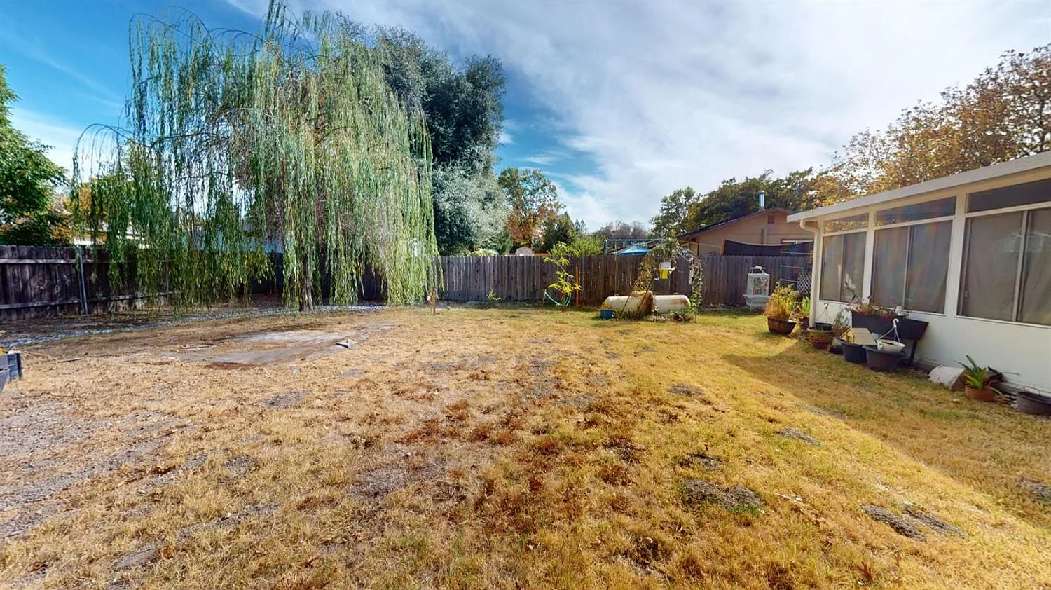 Backyard lawn beside the sunroom exterior
