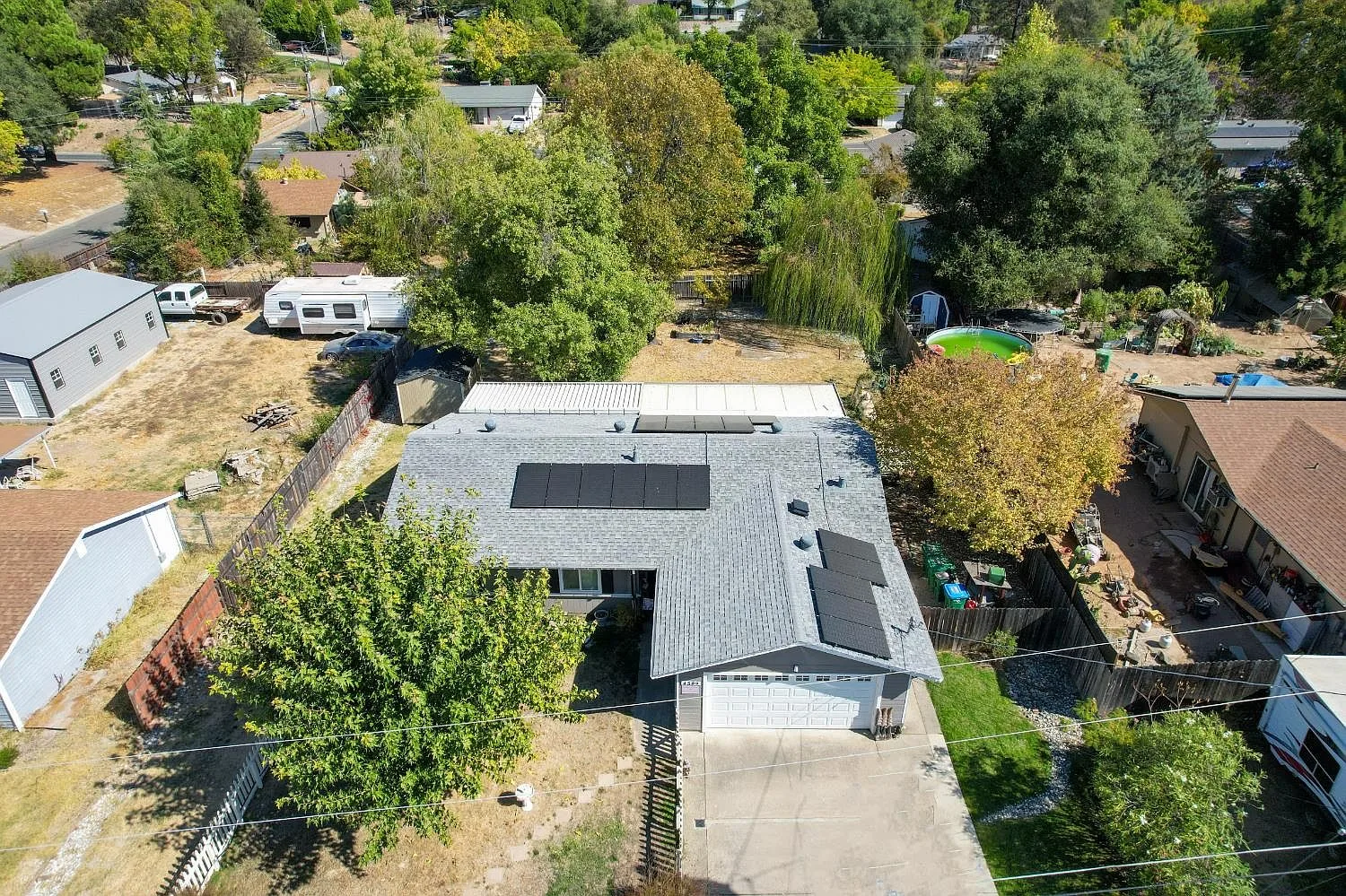 Aerial view of the home with rooftop solar panels