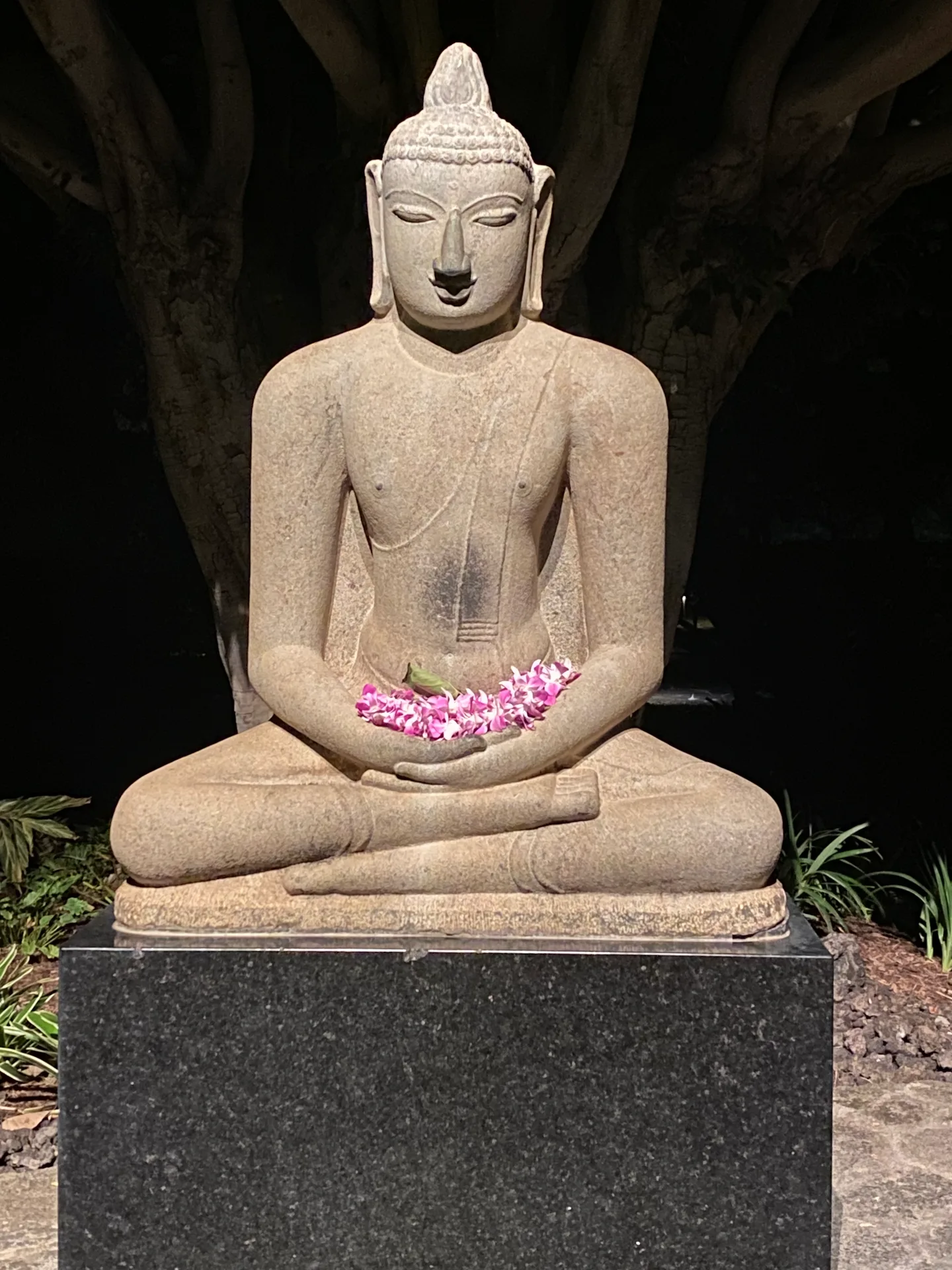 The 12th-century pink granite Buddha at the Mauna Kea Beach Hotel.