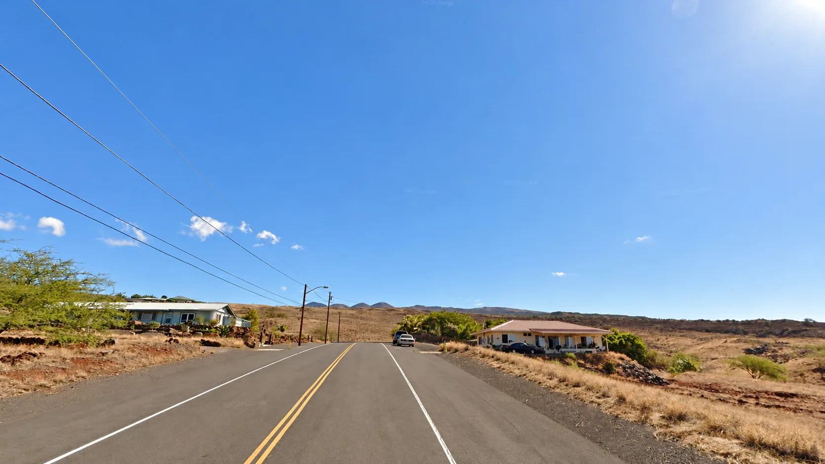 Street view in Kailapa with the cinder cones of Kohala Mountain above.