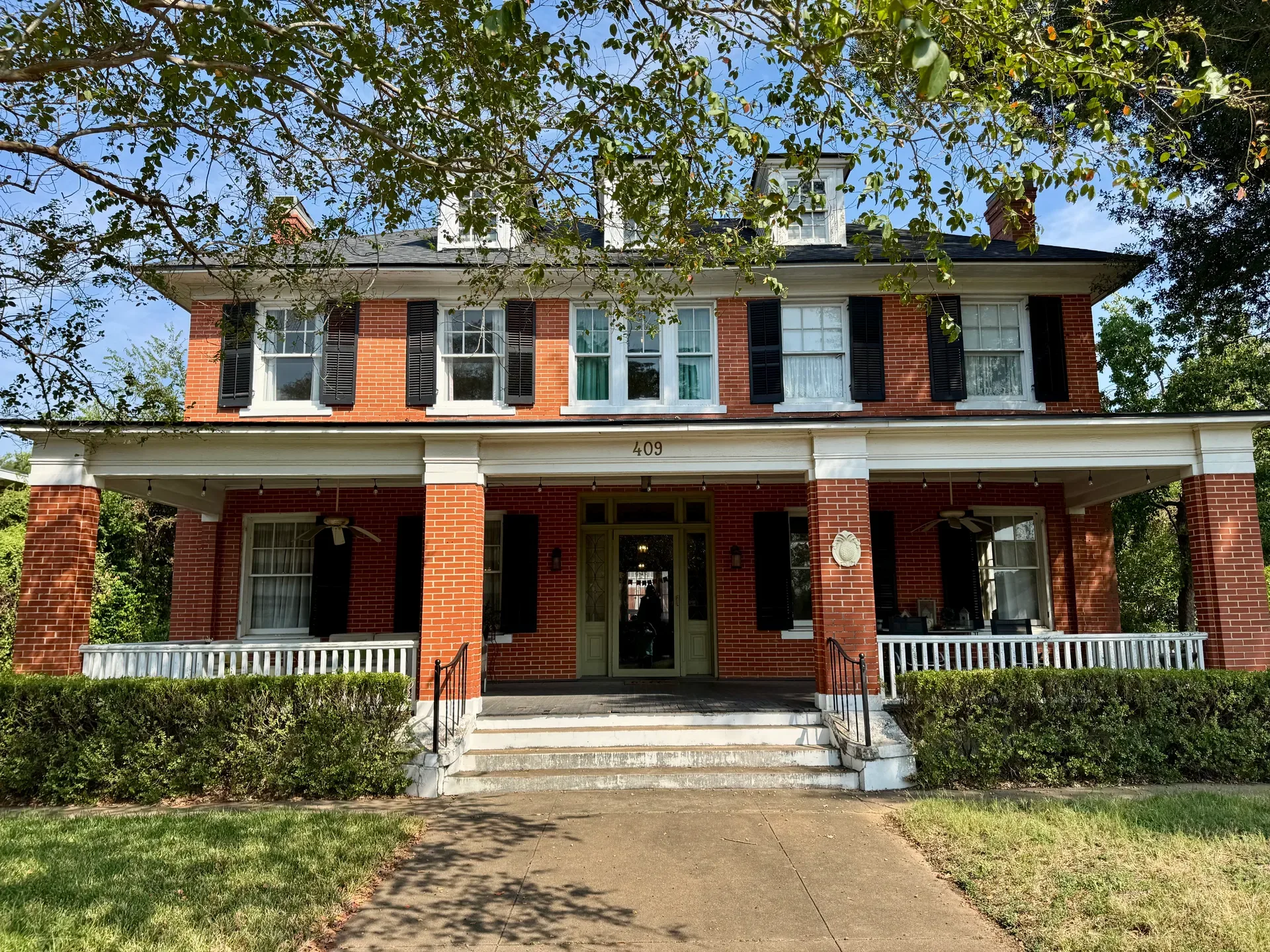 Historic brick facade of Main Street House bed and breakfast at 409 E Main St in downtown Brenham