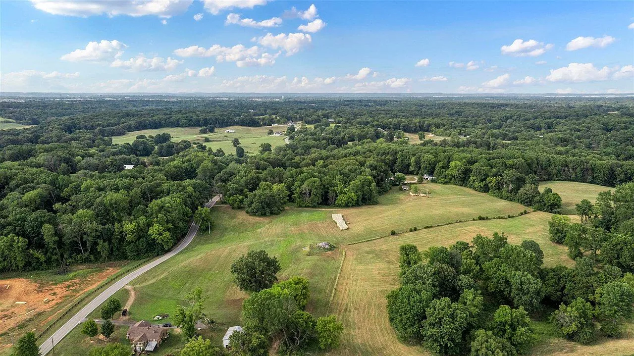 Aerial view of rolling green landscape with wooded areas