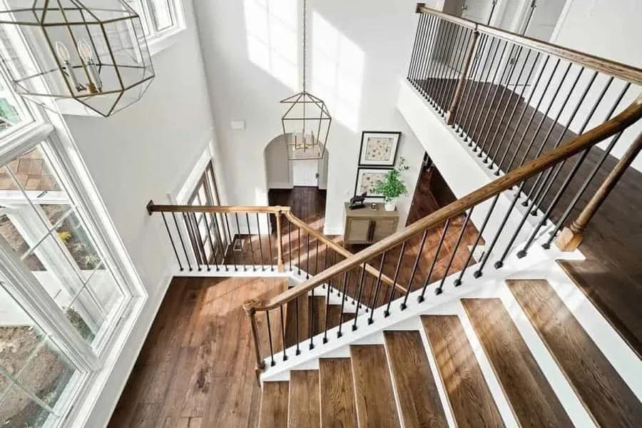 Grand two-story entryway with a sweeping staircase in natural daylight