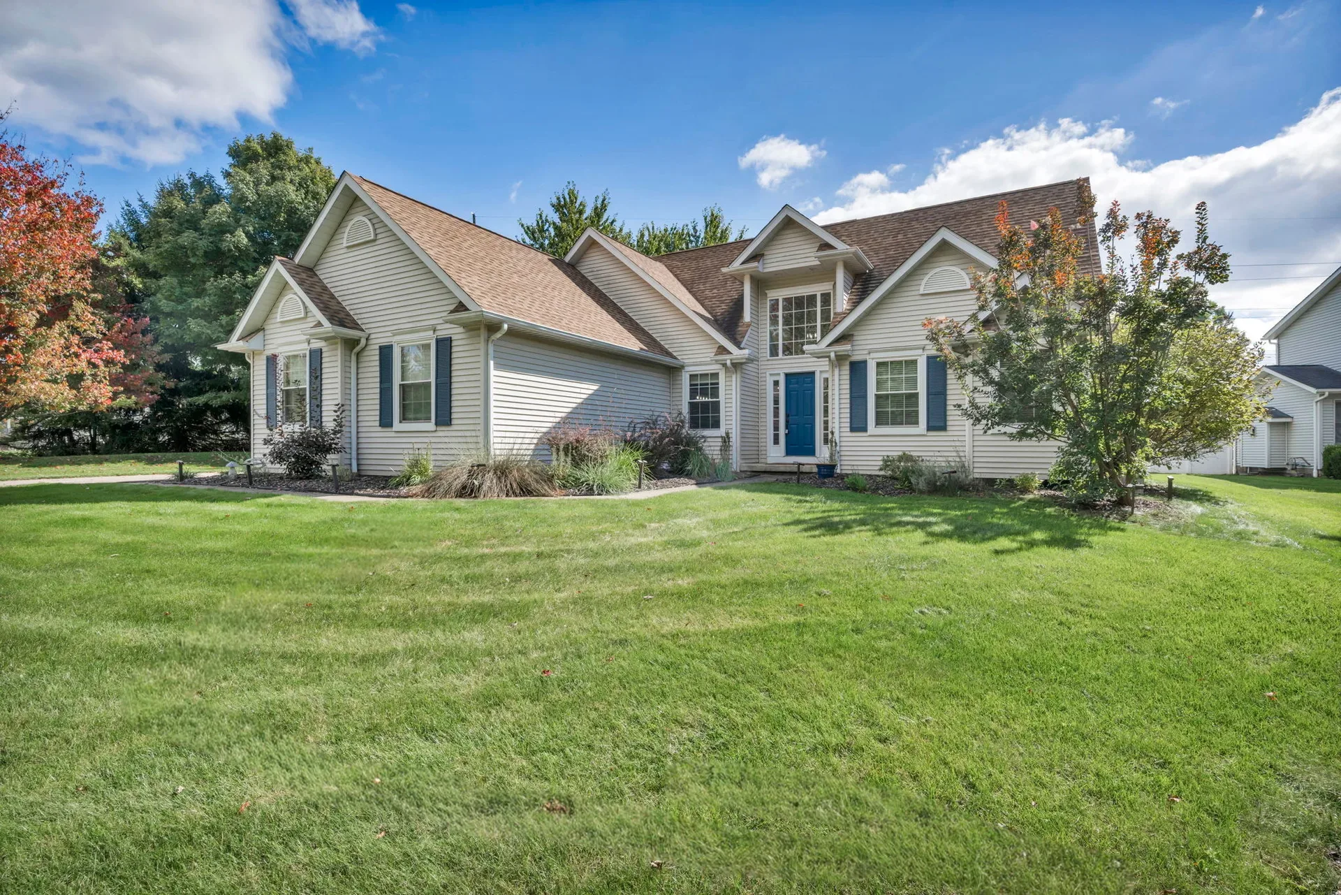 Wide front view of 188 W Sturbridge Dr with its lawn and blue shutters