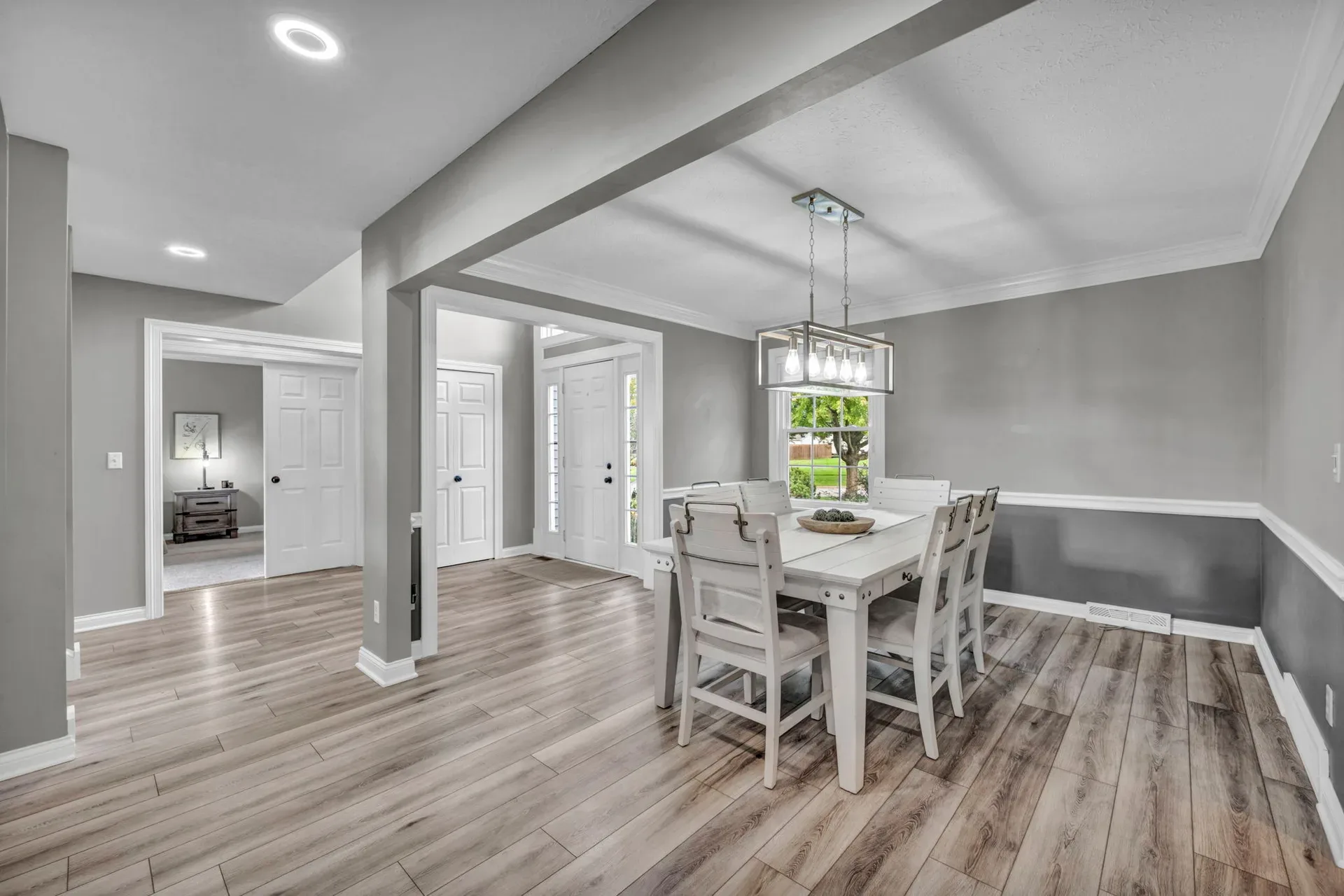 Open-concept dining area with gray and white walls