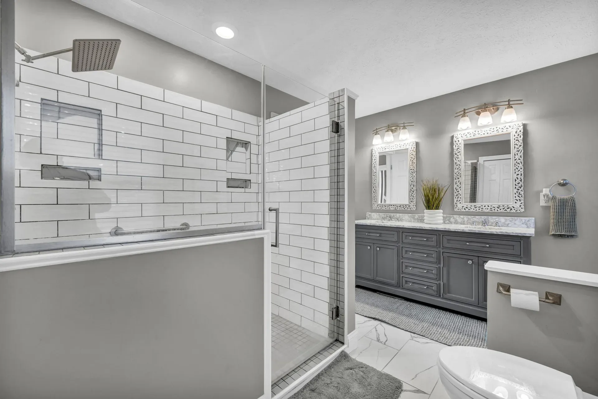 Modern bathroom with a subway tile shower and gray vanity