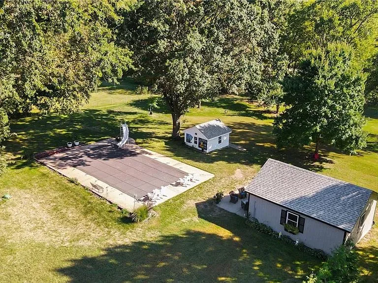 Aerial view of the backyard at 10035 W 55th Street showing the in-ground pool and mature trees