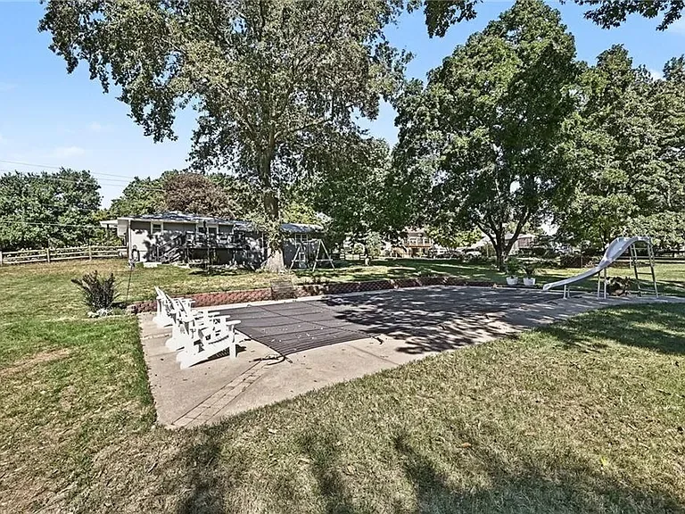 Pool and concrete patio behind the home at 10035 W 55th Street in Merriam