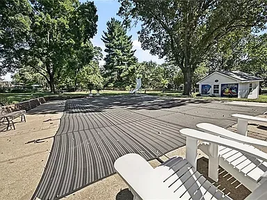 Pool deck with the covered in-ground pool and pool house at 10035 W 55th Street