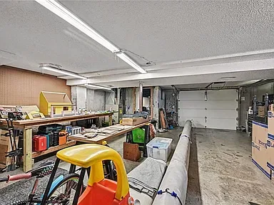 Workshop space with a workbench and storage inside the detached garage at 10035 W 55th Street