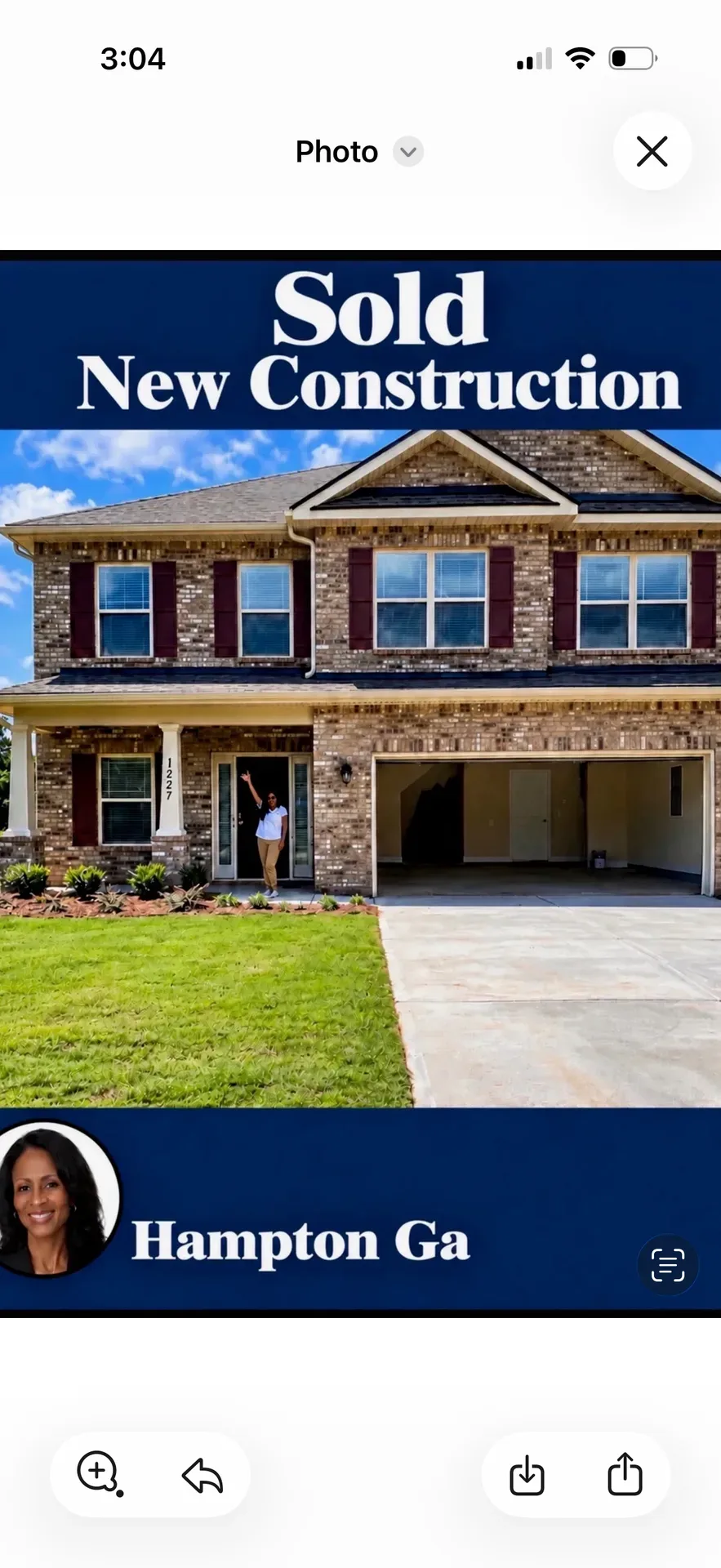 Two-story brick home with dark shutters and a Happy Closing Day banner with the agent portrait in Henry County