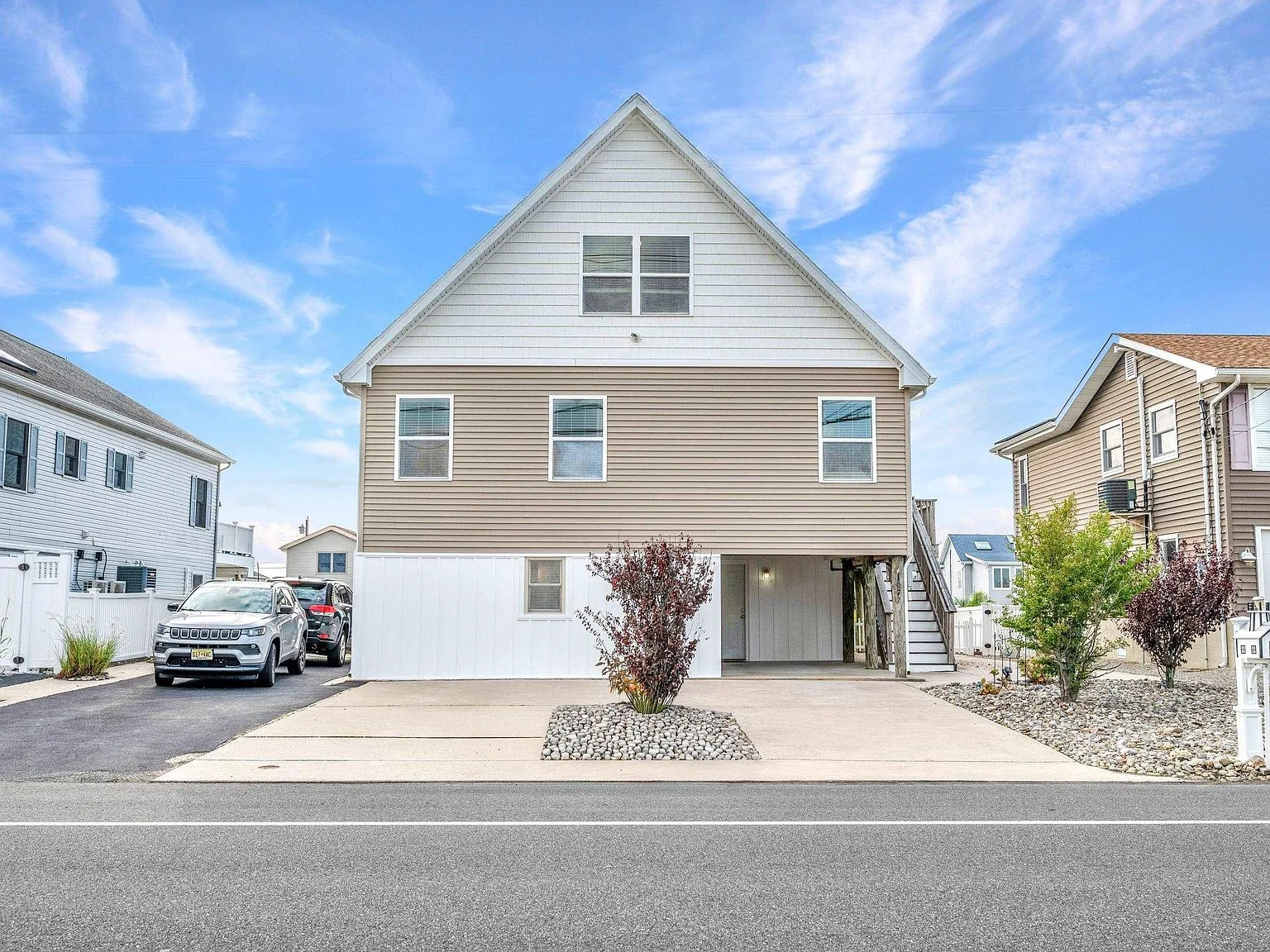 Front facade of the raised Cape home at 1072 Radio Rd in Little Egg Harbor, NJ