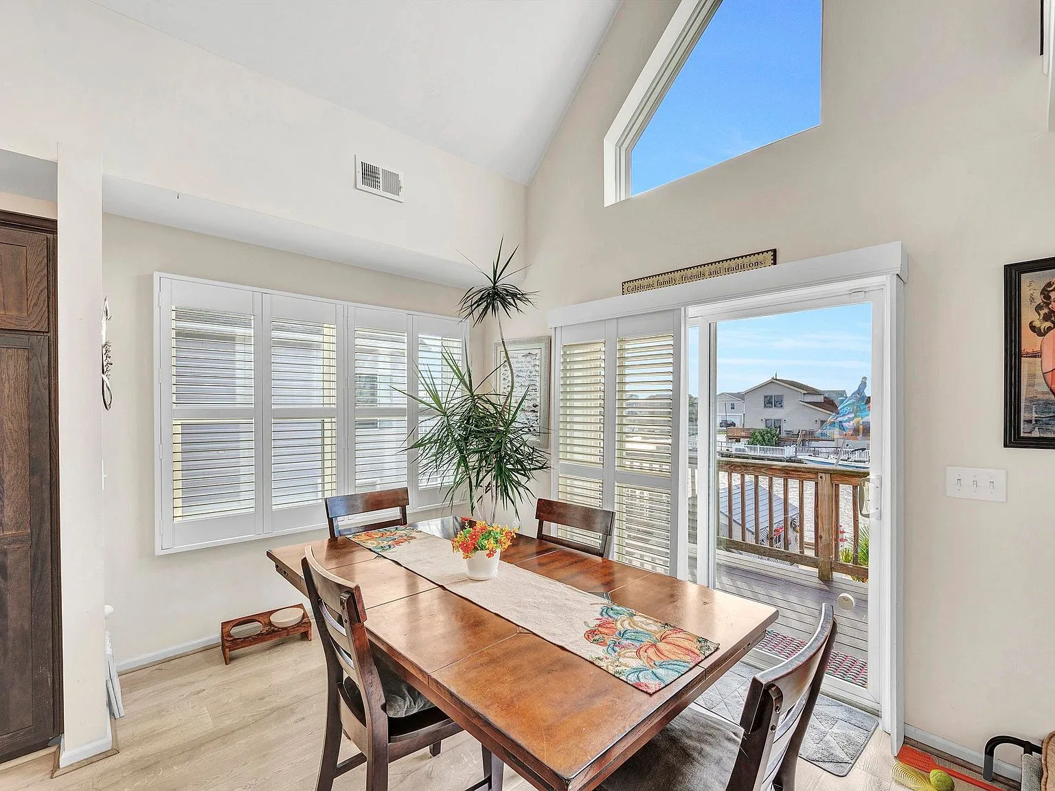 Dining area with vaulted triangular window