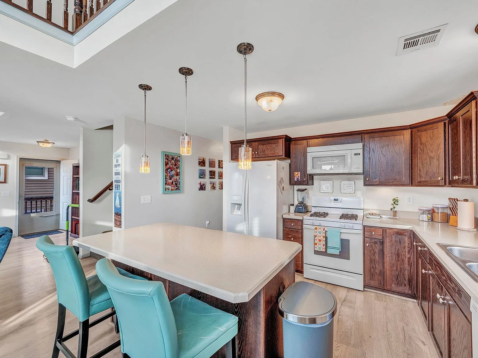 Kitchen with wood cabinetry and light counters
