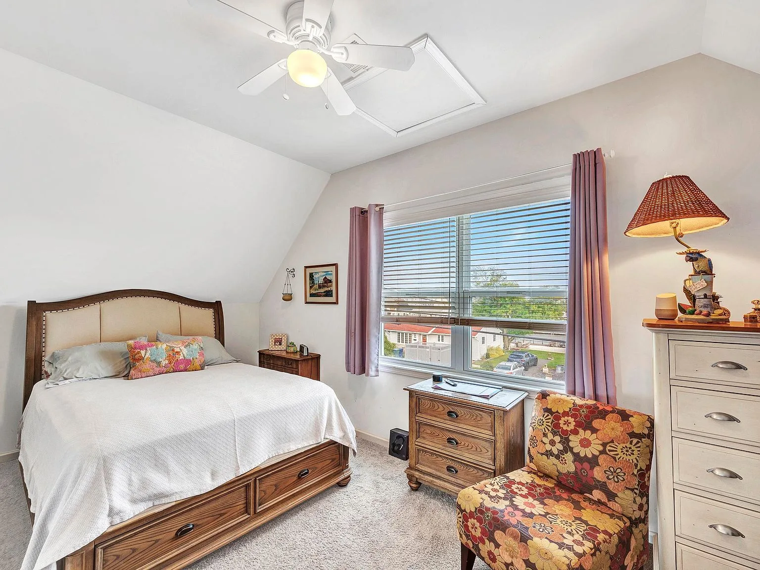Upper-level bedroom with sloped ceiling