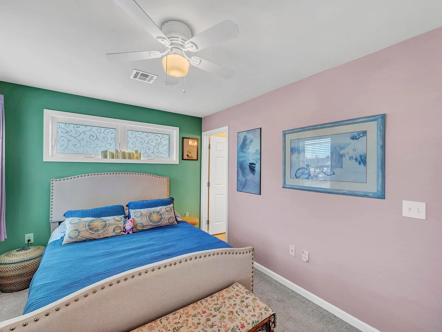 Bedroom with green and lavender accent walls