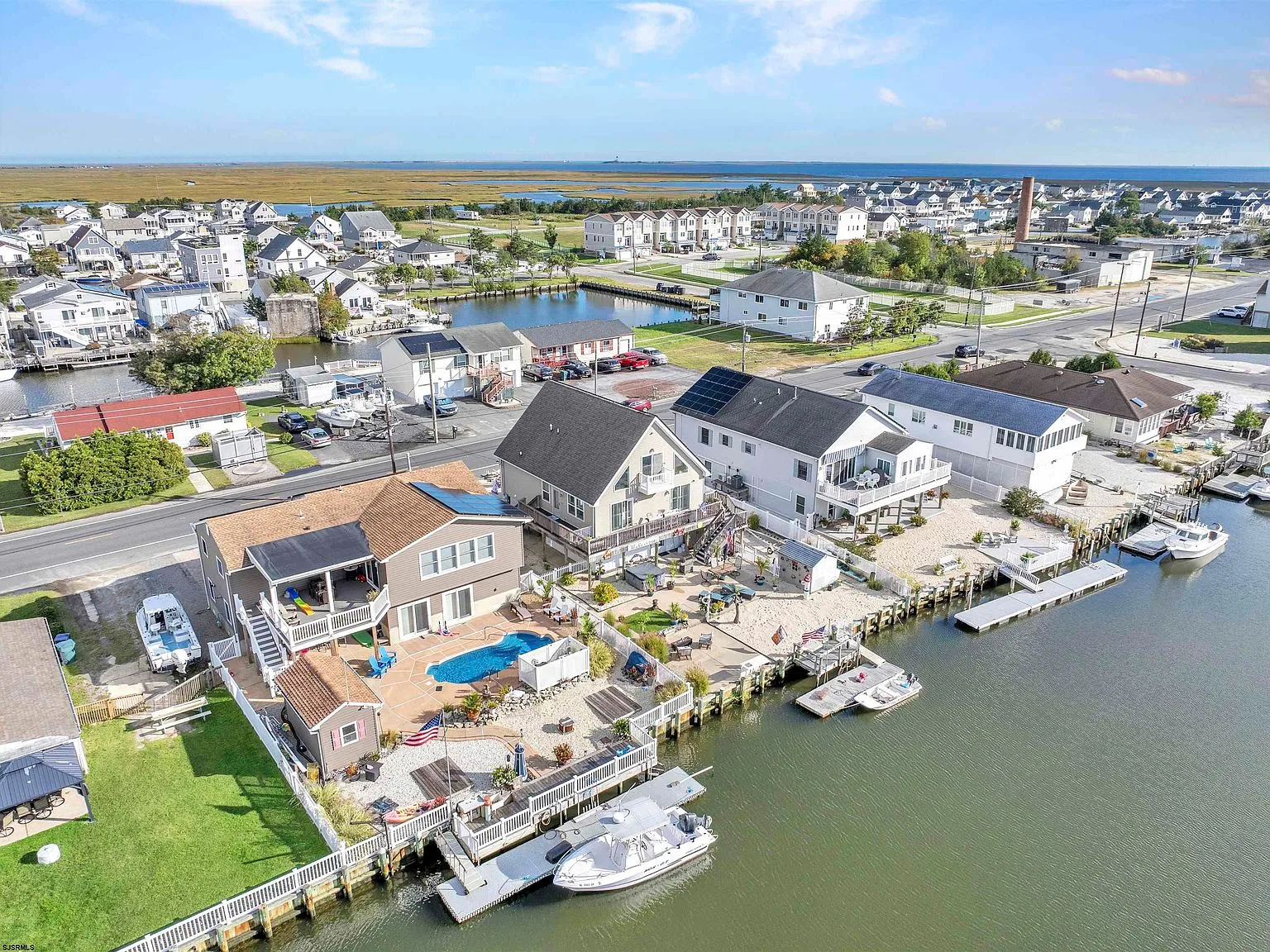 Backyard and dock of a raised coastal home on the lagoon