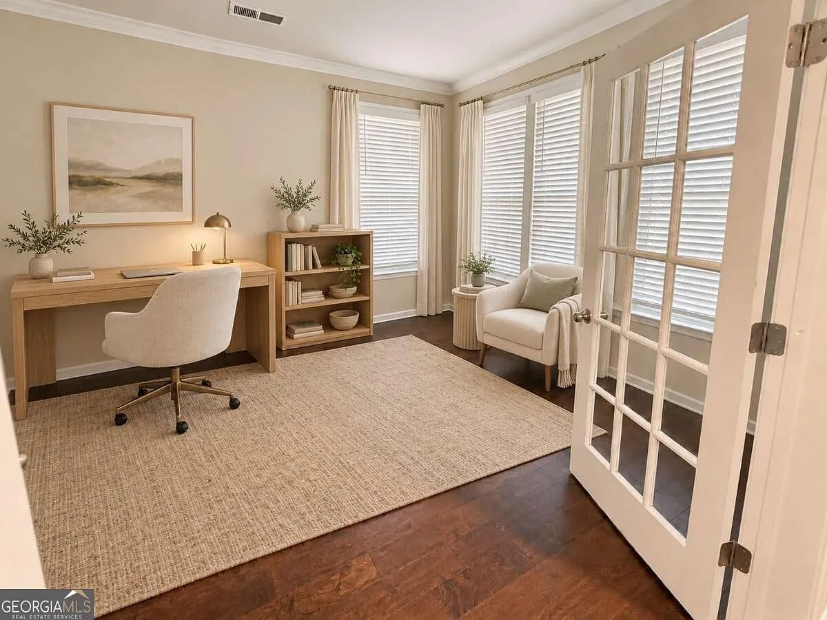 Main-level home office with glass-paneled French doors and a desk